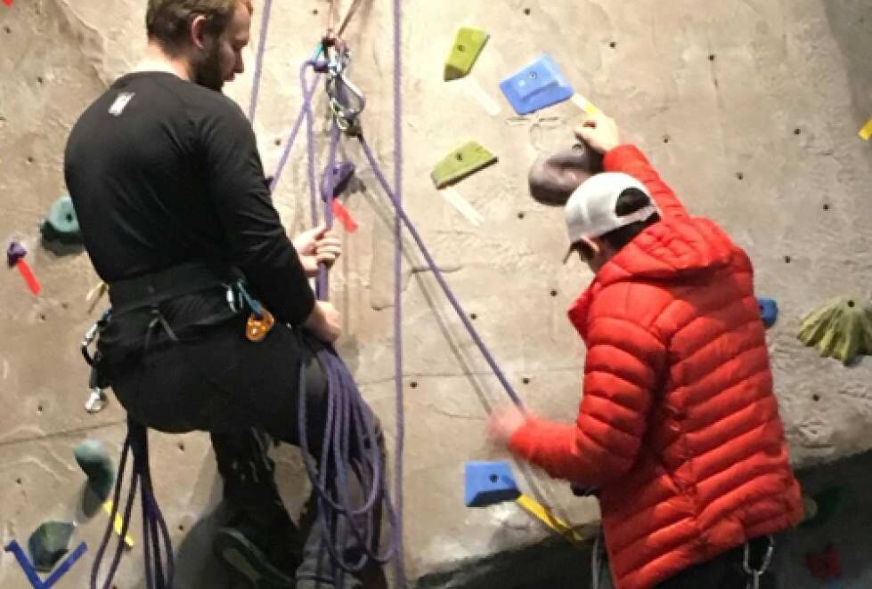 two students practicing a mini-multipitch climb on our indoor wall
